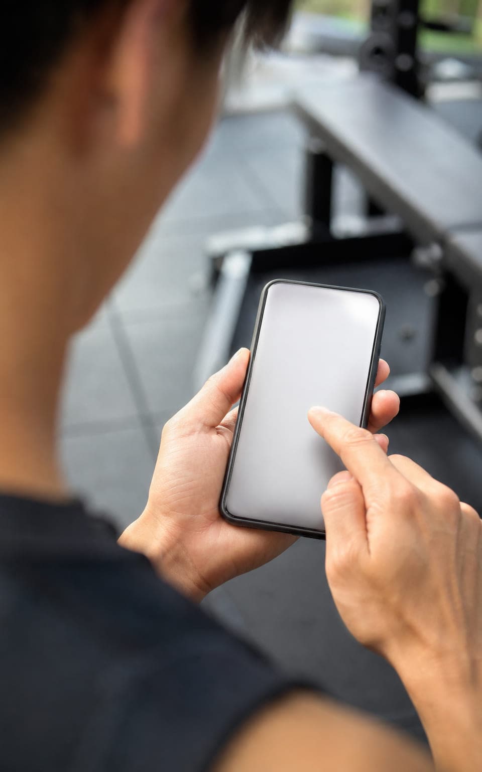 ジムでスマートフォンを操作する手元